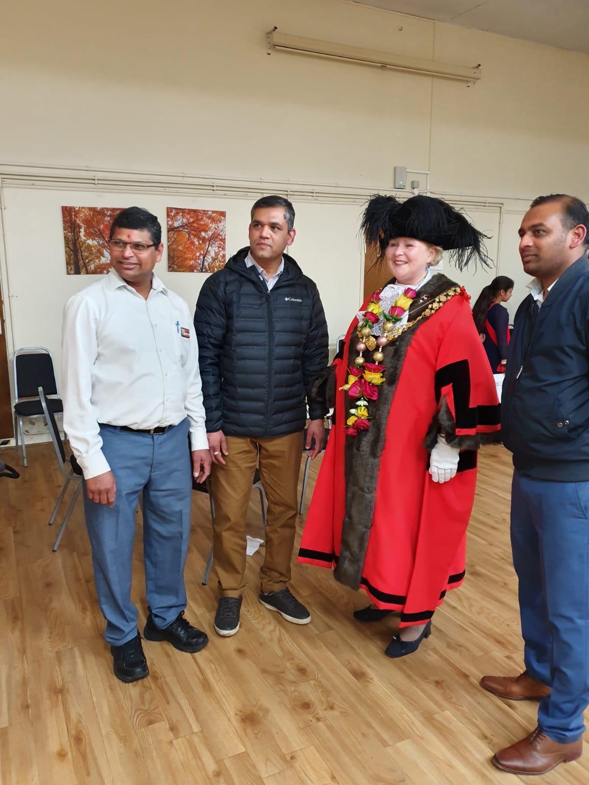 Members of Great Hindu Sabha UK welcoming the local Mayor at a community celebration